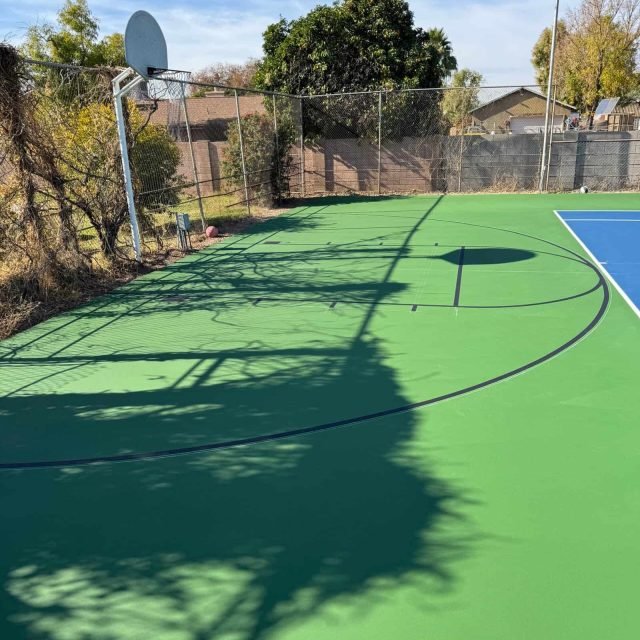Bright, newly resurfaced court ideal for basketball and pickleball, showcasing professional court painting services.